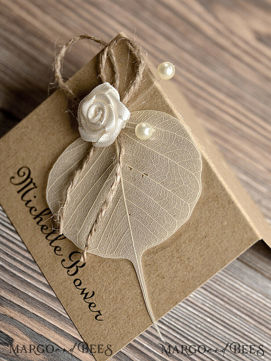 PLATZKARTEN / TISCHKARTEN  
 Rustikale Eco-Hochzeitsplatzkarten Rustikale Eco Braune Hochzeitsplatzkarten, zarte Hochzeitsnamensschilder mit weißer Rosendekoration, Jute-Schnur und getrocknetem Blatt, einzigartige ökologische Hochzeitsstationery, bearbeitbarer Text